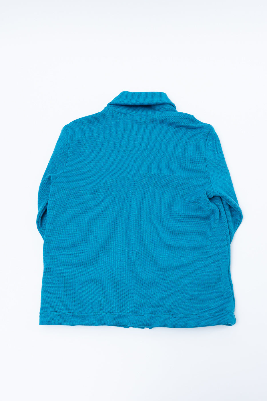 Flat lay of aqua shawl sweater coat showing back, collar, and knit fabric texture.