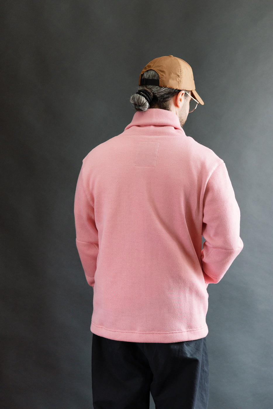 Male model 5'9 165lbs athletic build, wearing bubblegum pink shawl sweater coat, back view, full body