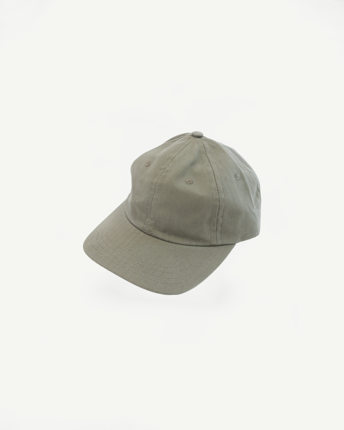 Dry Wax Cotton Baseball Hat - Sage: An unstructured six-panel cap in muted olive, featuring a flat brim, tonal eyelets, and an adjustable self-fabric strap with an antique brass slider.
