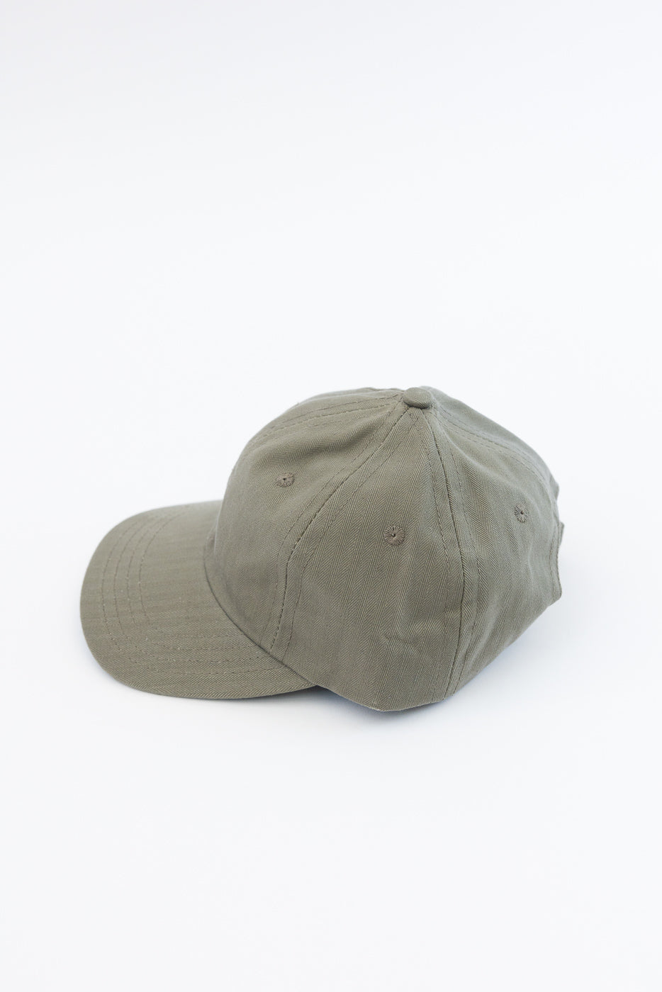 Dry Wax Cotton Baseball Hat - Sage: An unstructured six-panel cap made from 12oz dry wax cotton canvas with a flat brim, tonal eyelets, and an adjustable strap with antique brass slider.