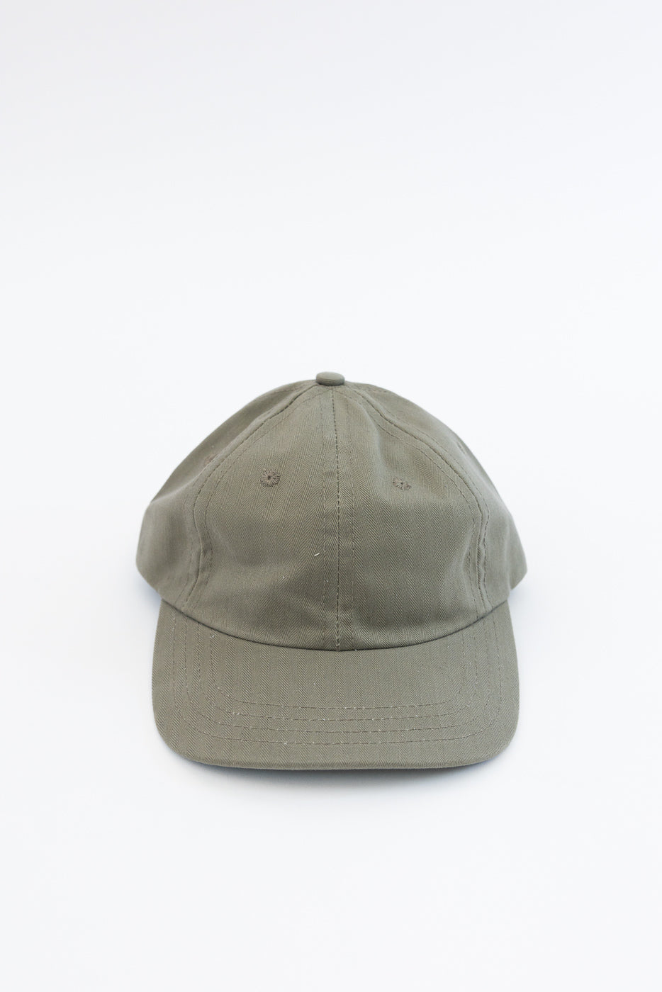 Dry Wax Cotton Baseball Hat - Sage, showcasing a six-panel design in olive-green wax cotton canvas with a matte finish, mid-profile crown, flat brim, tonal eyelets, and an adjustable strap with brass slider.