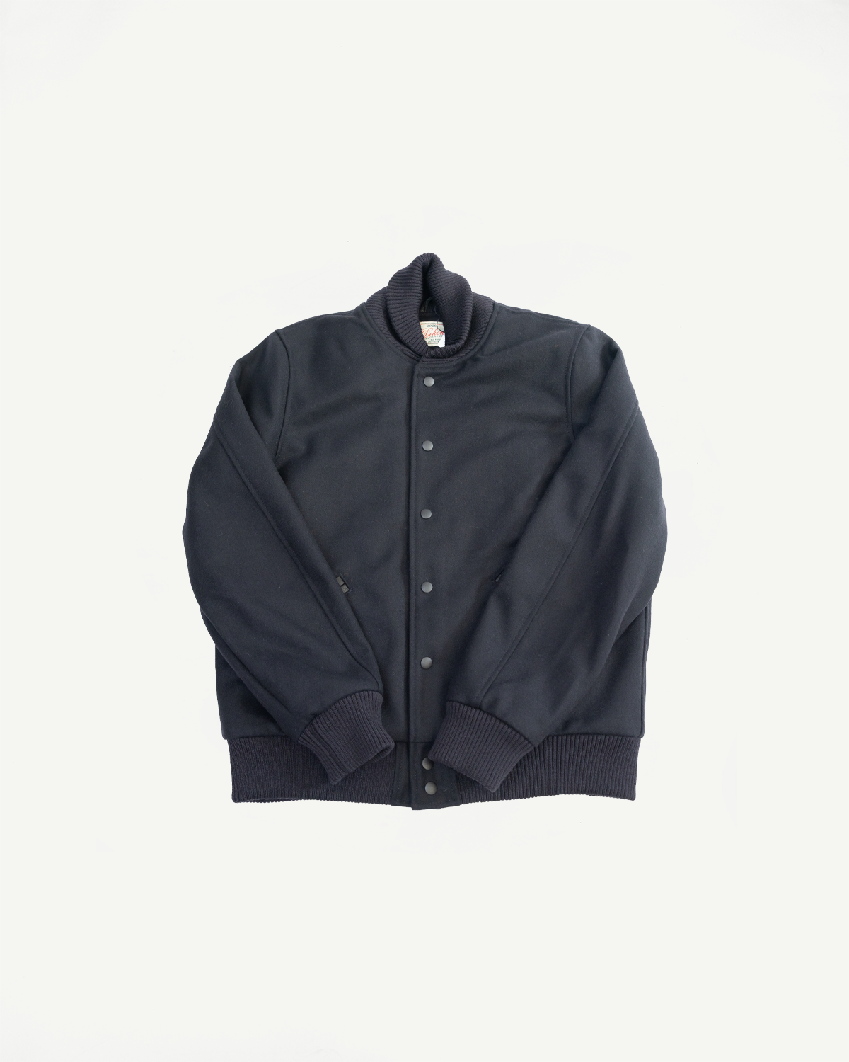 all black varsity jacket on white background, flat lay, front