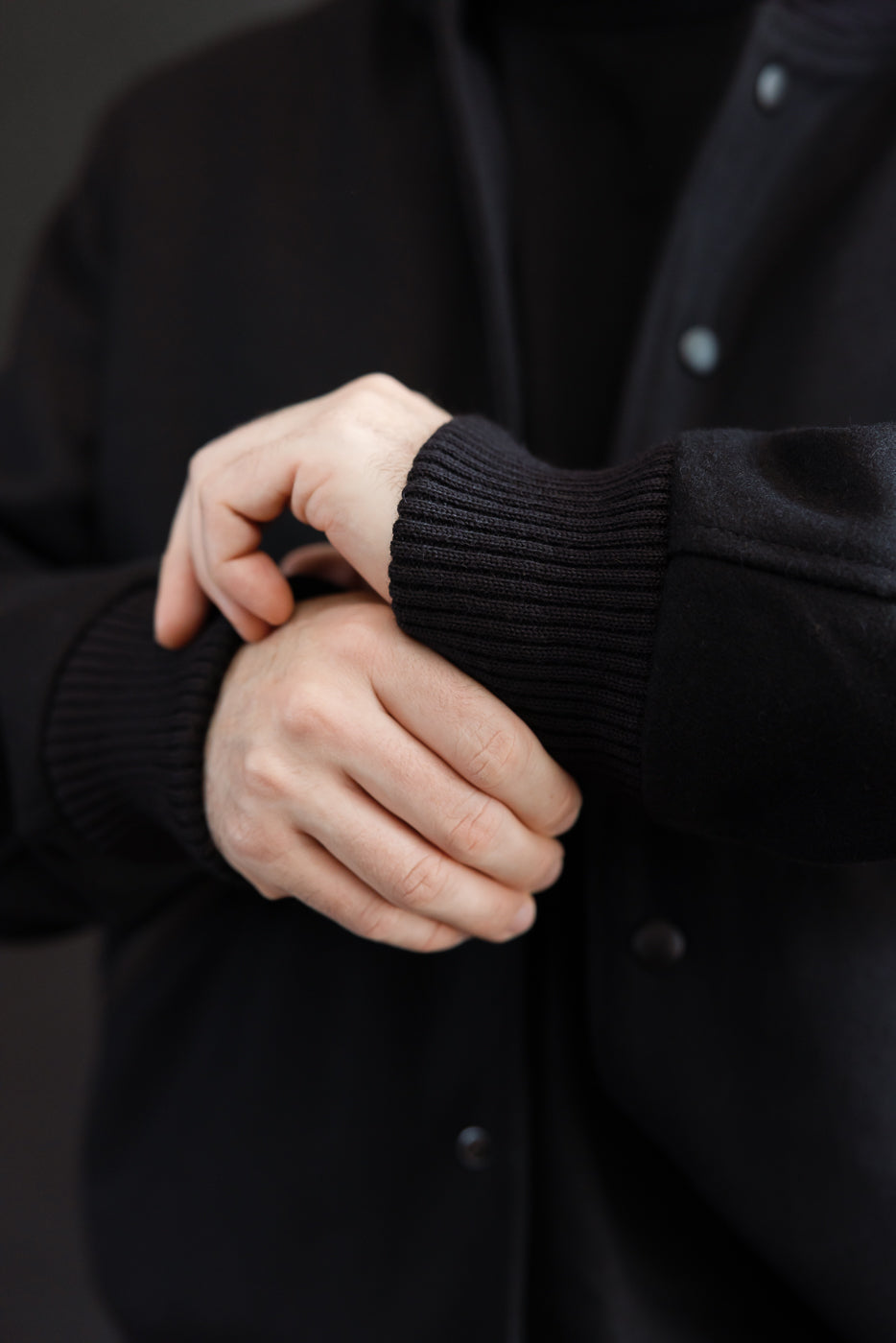 close up detail of ribbed cuffs on black jacket
