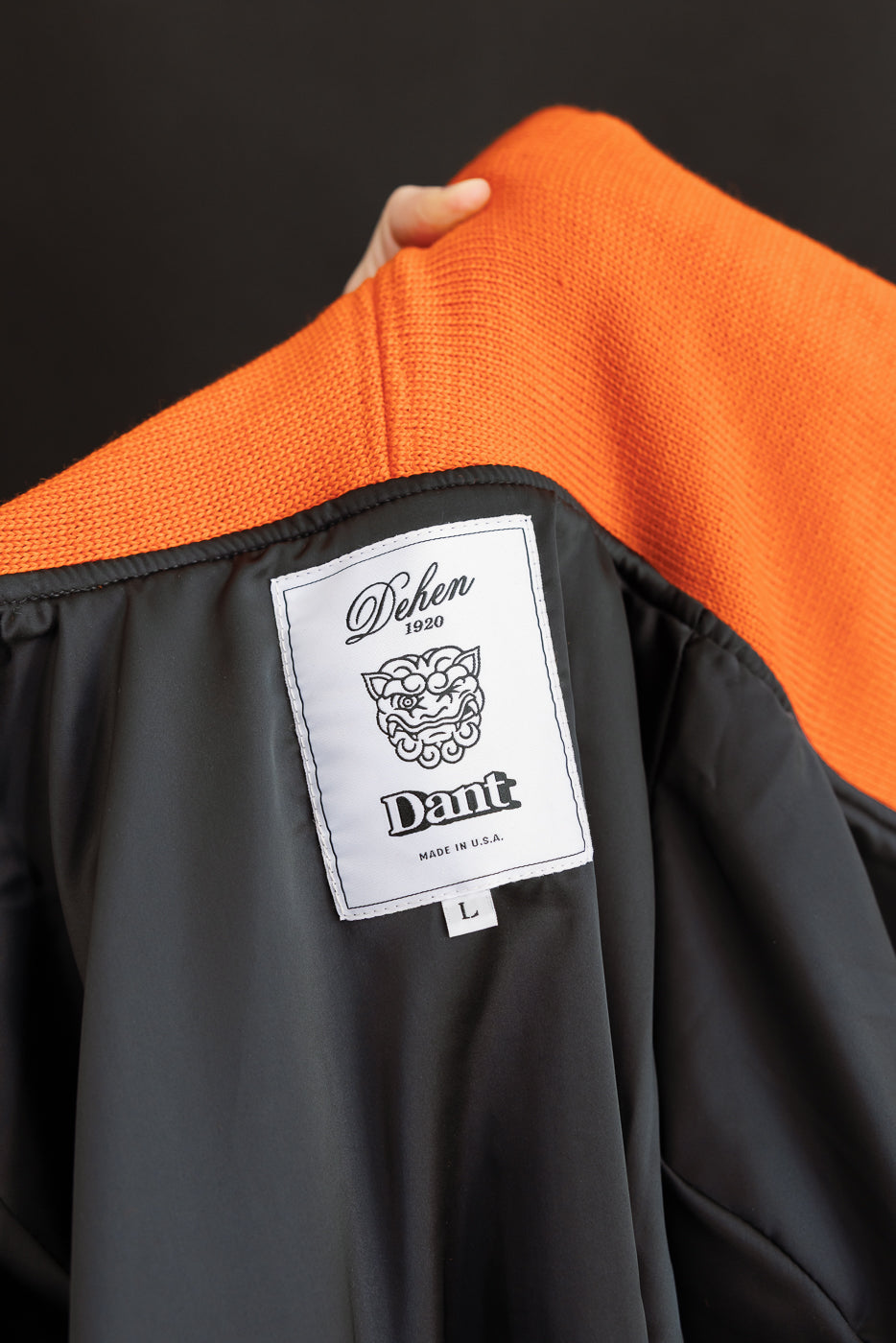 close up of dehen x dant label in white on interior of hoodie