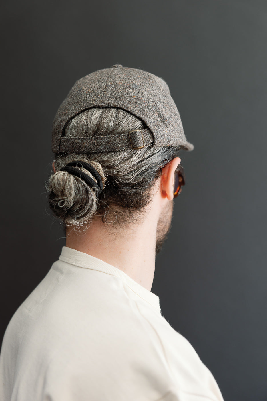 Close-up back view of a grey textured cap on a male model (5'9