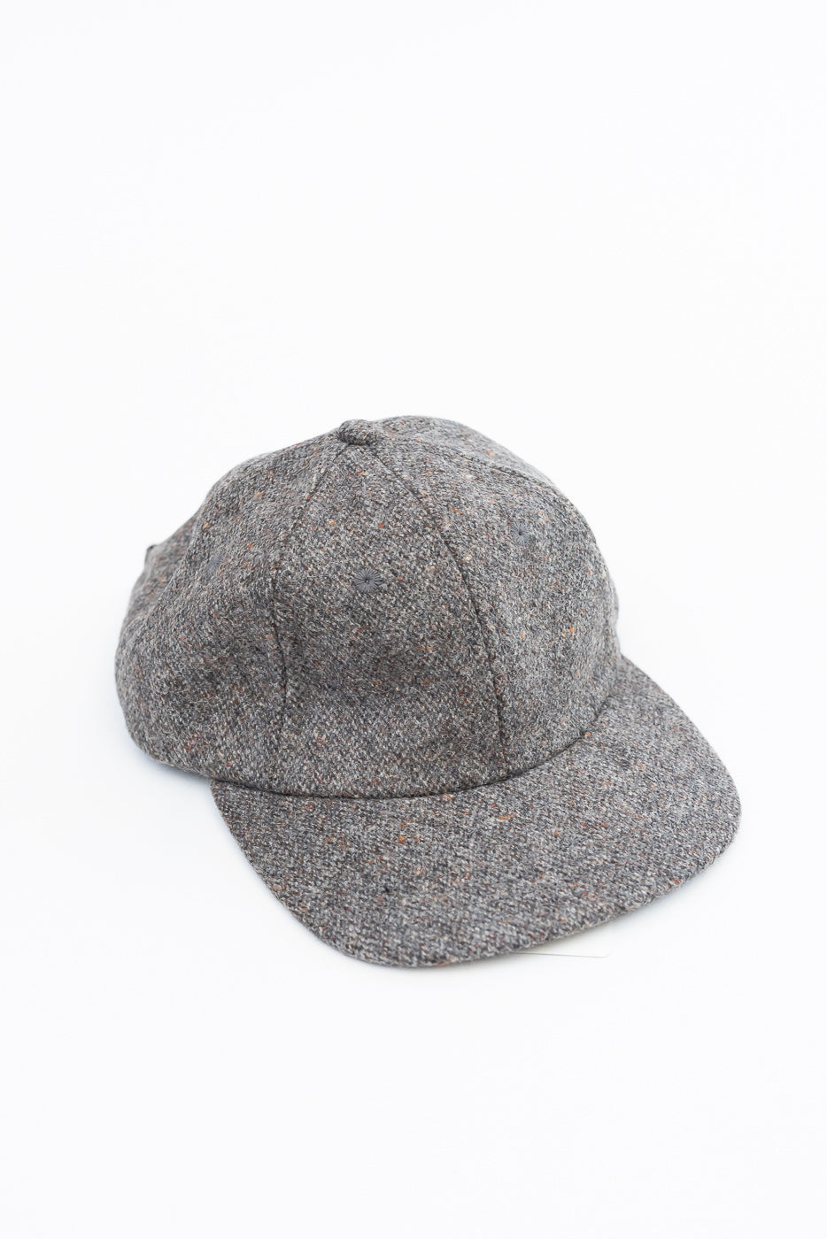 Front view flat lay of a grey textured fabric baseball cap on a white background.