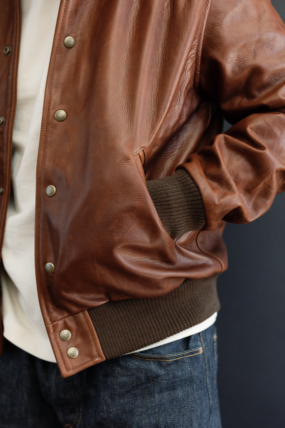 Close-up of right side of brown leather jacket on male model (5'9