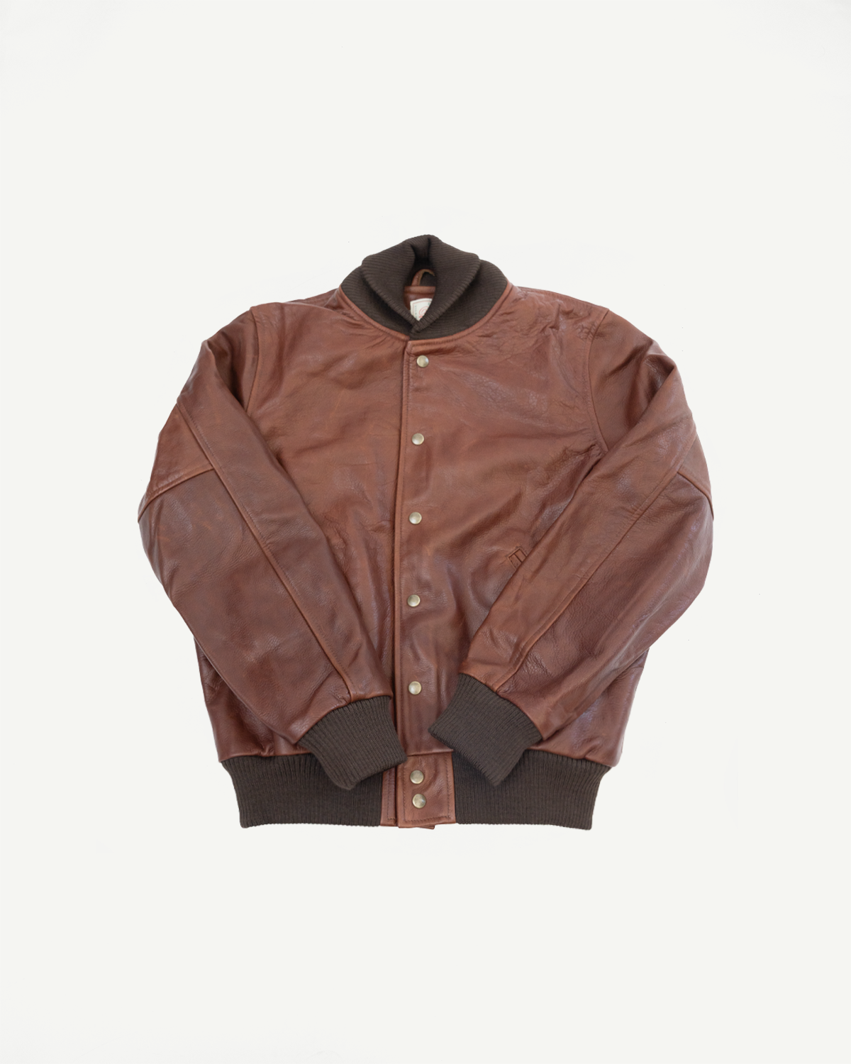 Front view flat lay of a brown leather varsity jacket with ribbed collar and cuffs.