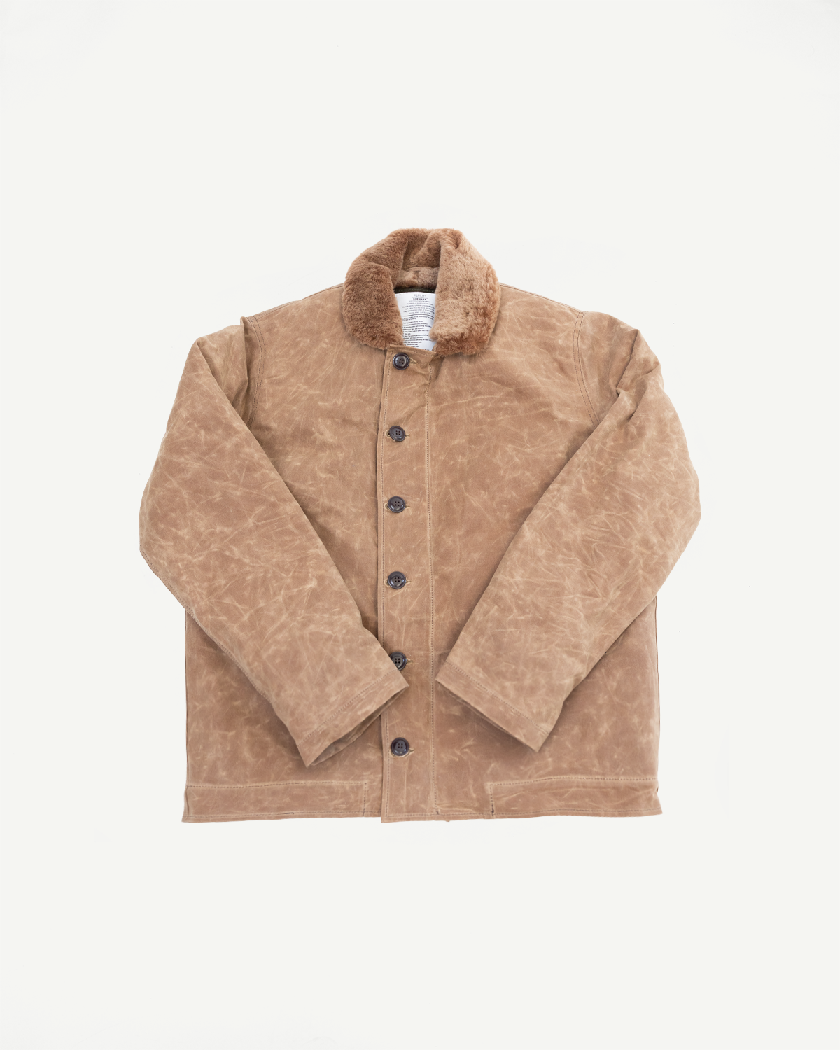 Front view flat lay of a tan waxed canvas jacket with a brown faux fur collar.