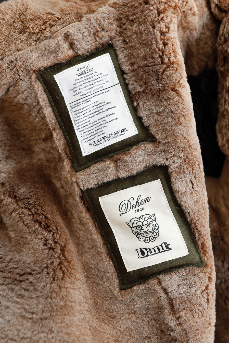 Close-up of the interior back neck area showing Dehen 1920 and care labels on brown faux fur lining.