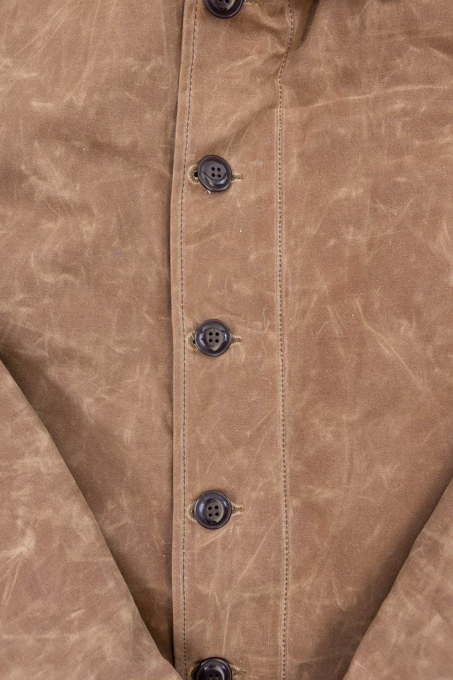 Close-up of the front button placket and brown fabric texture of a casual jacket.