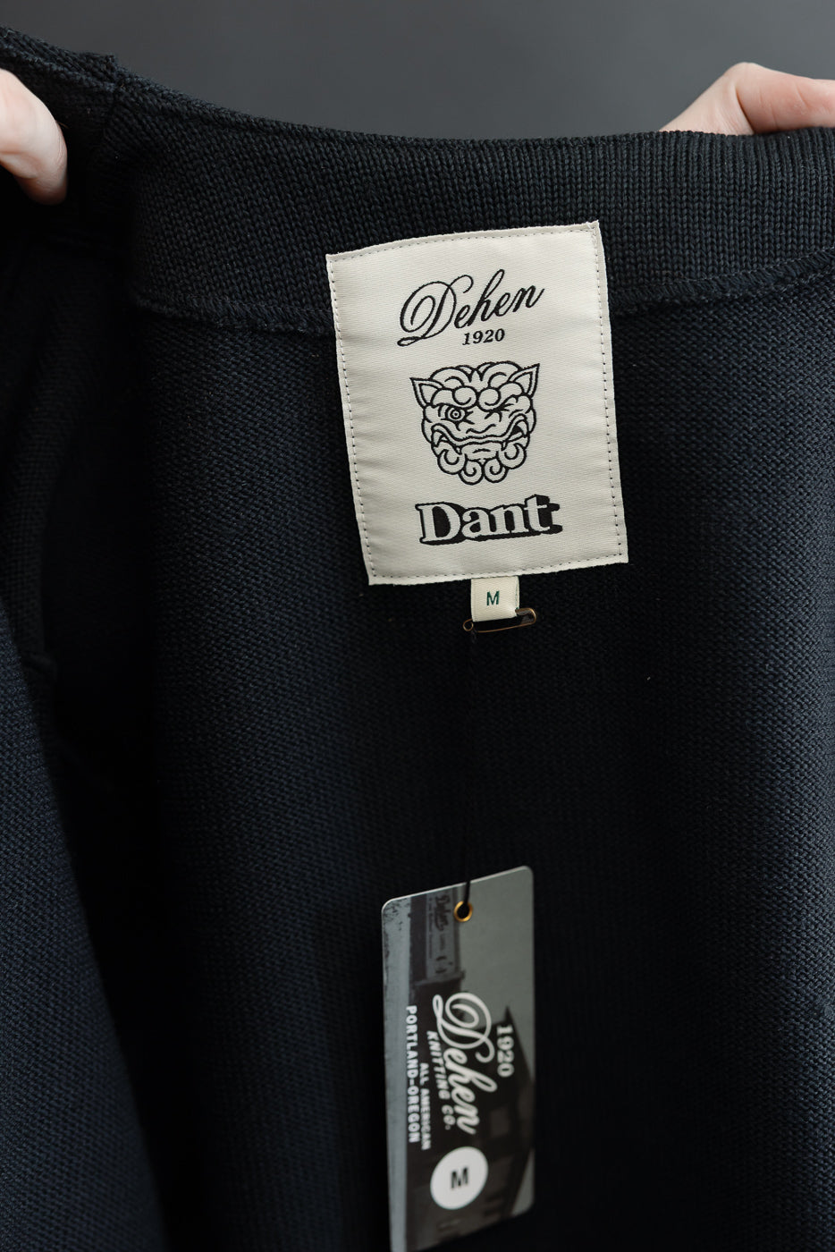 Close-up of the inner back neck area showing the white Dehen 1920 brand tag and size M label.