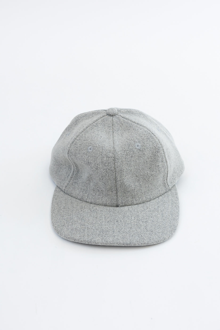Front view flat lay of a grey wool baseball cap showing fabric texture.