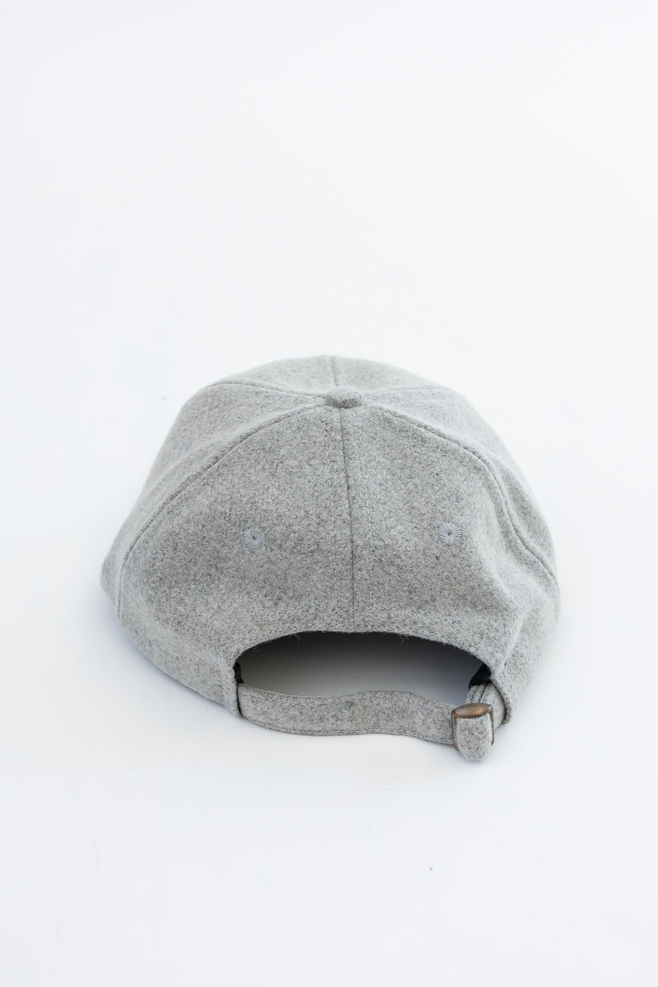 Back view close-up of a grey felt baseball cap showing the adjustable strap and fabric texture.