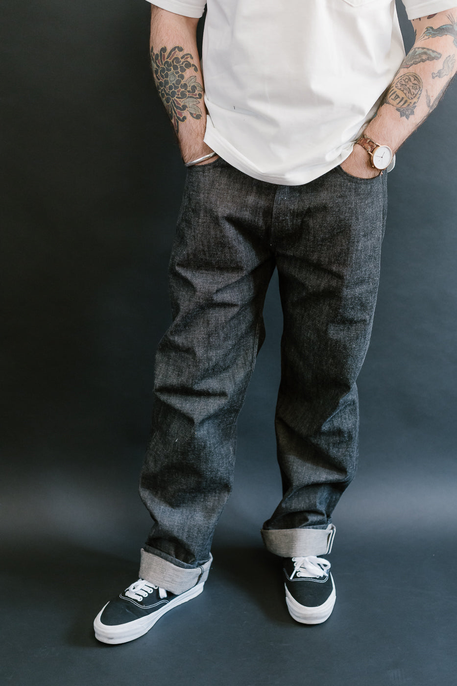 man wearing denime black mother cotton denim jeans 3/4 view, front