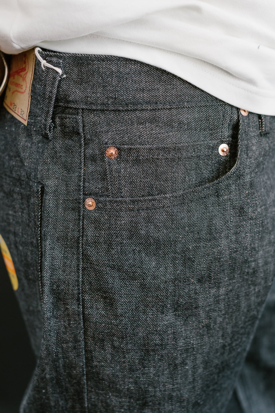 close up of on body denime black x mother cotton coin pocket and rivets