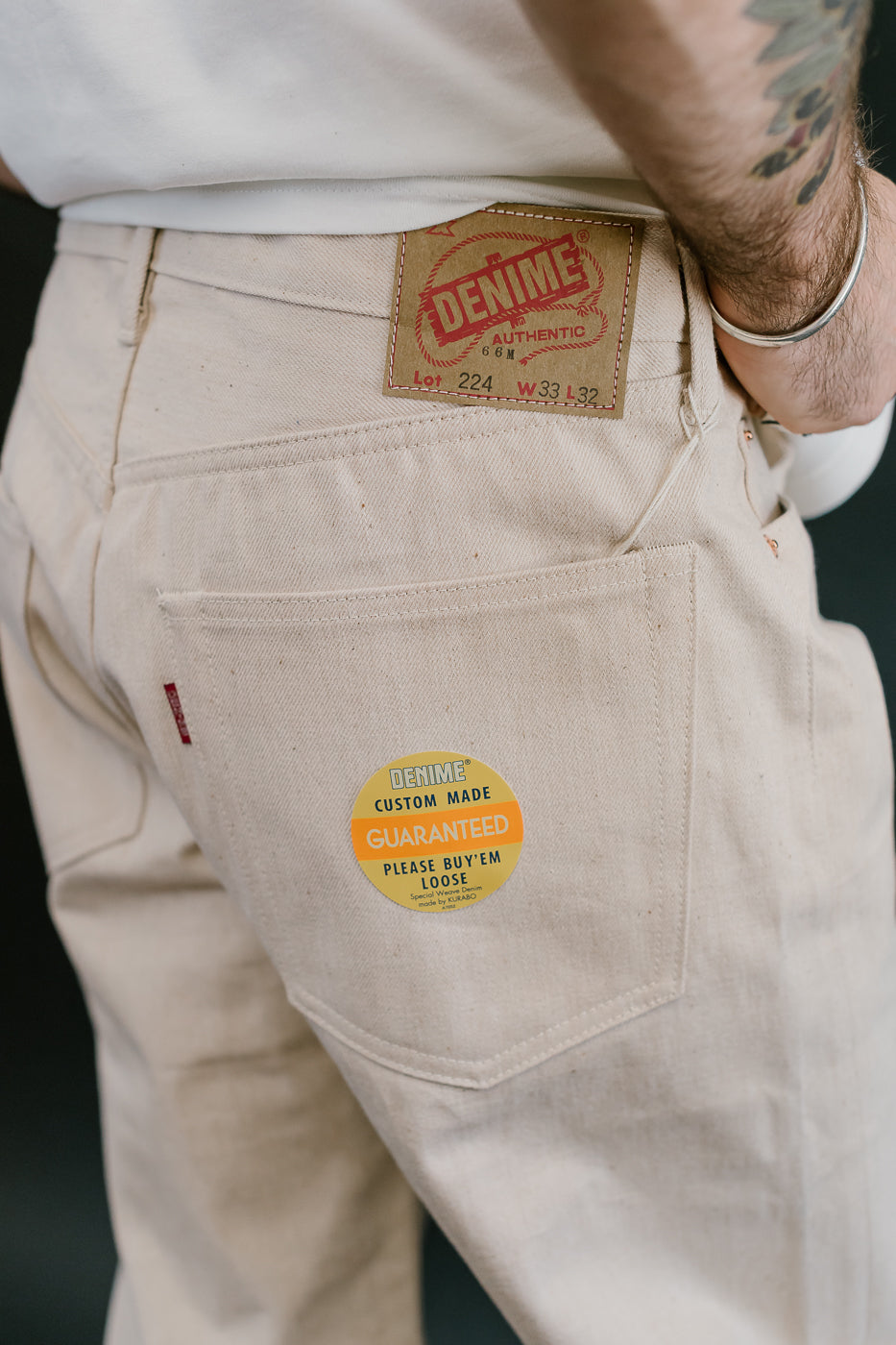 Beige pants with Levi's branding and a visible tag on the back pocket.