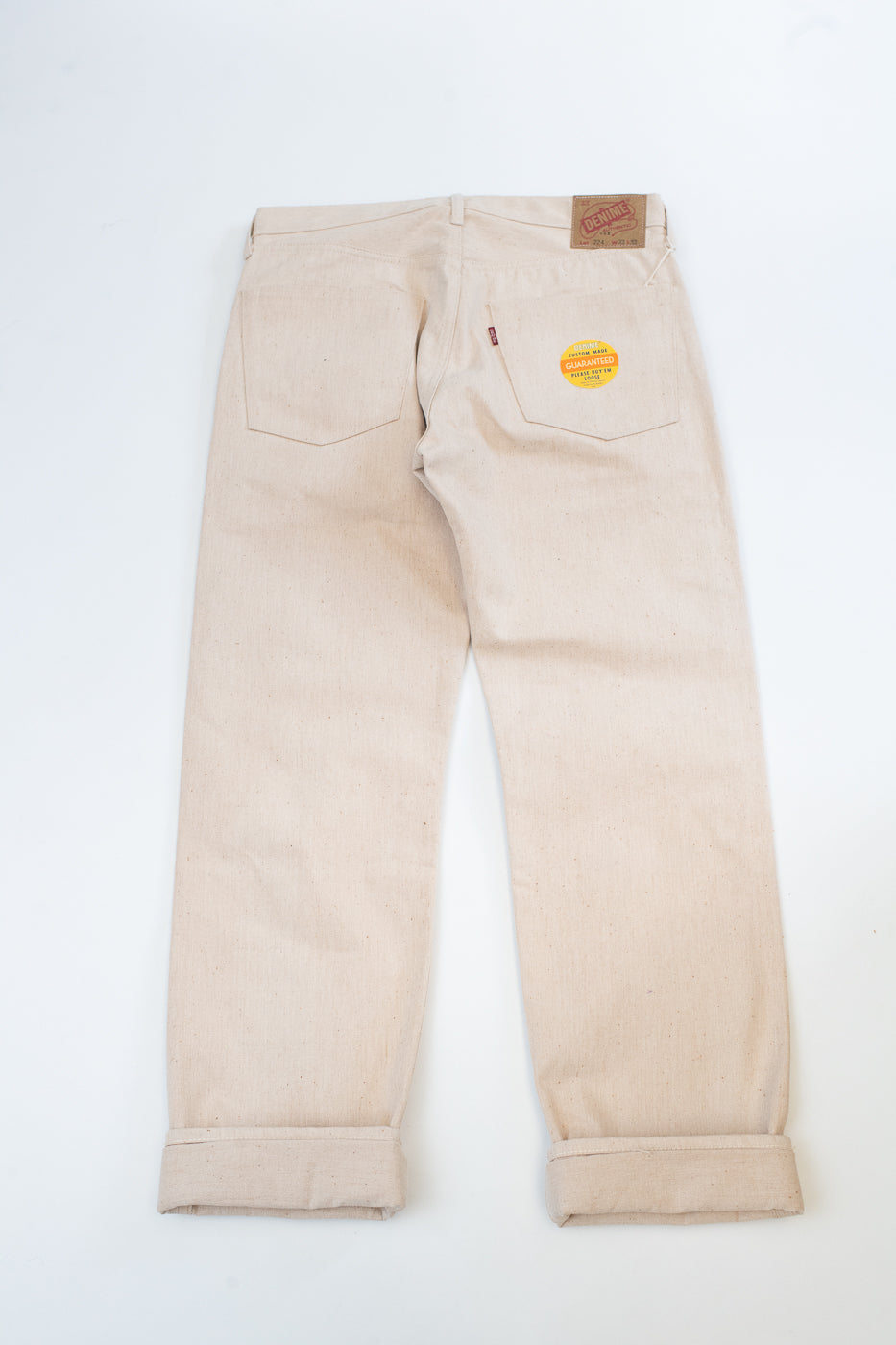 Beige pants with a patch on a white background
