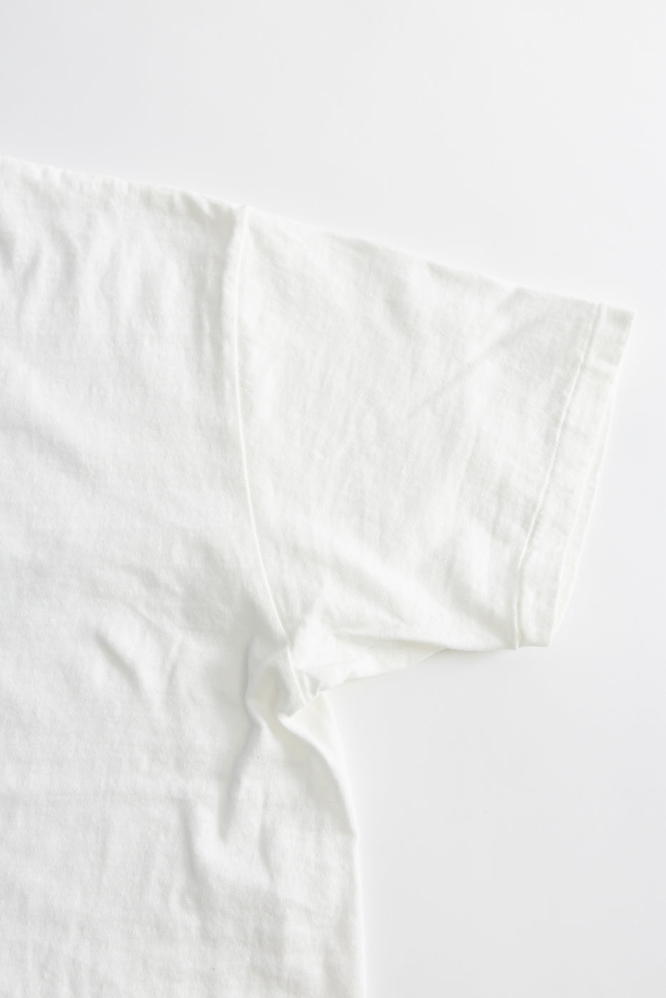Close-up of the 5.4oz Raffy Tenjiku Printed T-Shirt Seaplane - Off White, showcasing a tubular knit design with no side seams, highlighting the premium slub jersey texture for a vintage-inspired look.