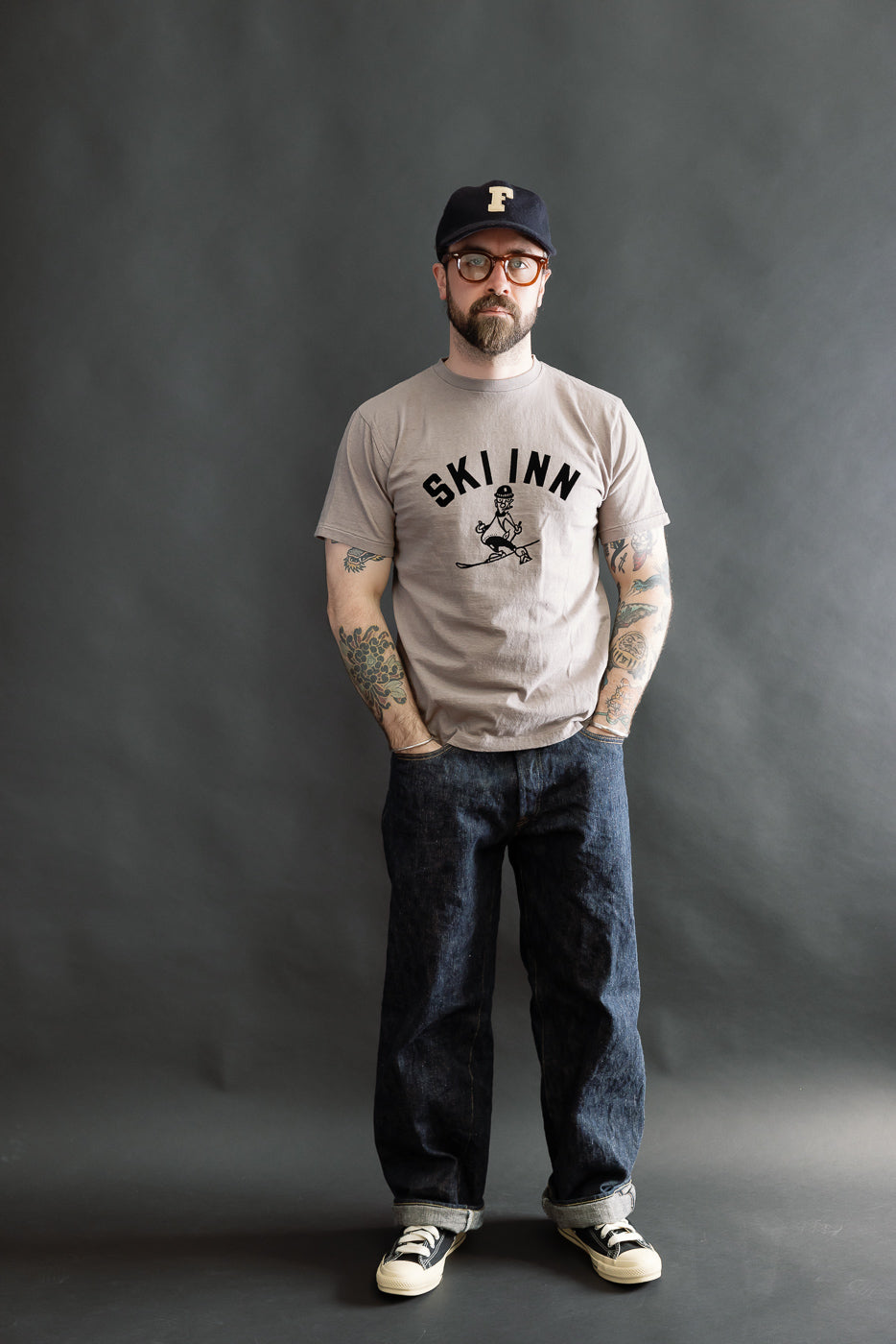 5.4oz Raffy Tenjiku Printed T-Shirt Ski Inn - Grey worn by a 5'9 Caucasian male with tattoos, styled with denim jeans and canvas sneakers, embodying vintage-inspired American workwear.