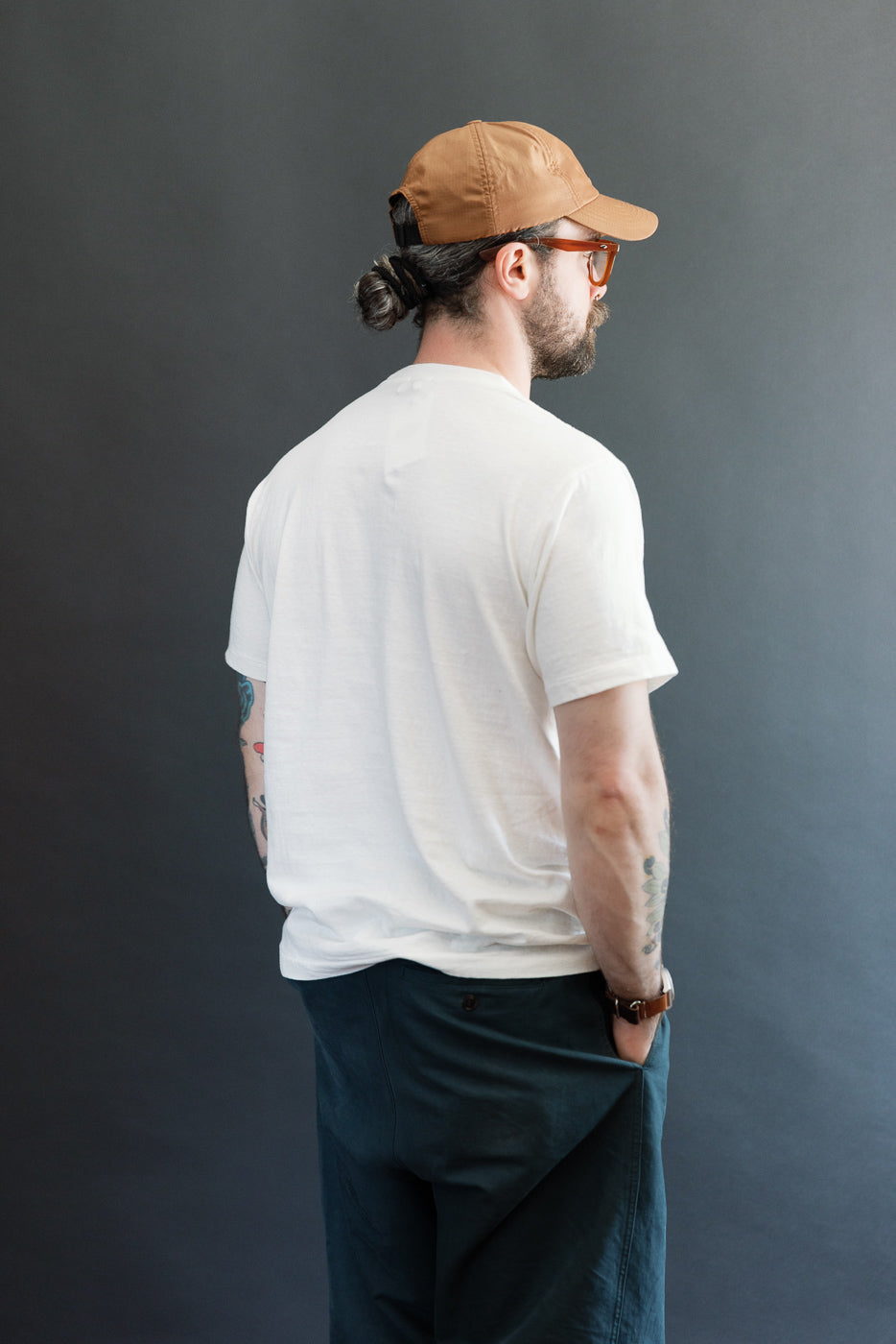 Back view of a white t-shirt on a male model, 5'9
