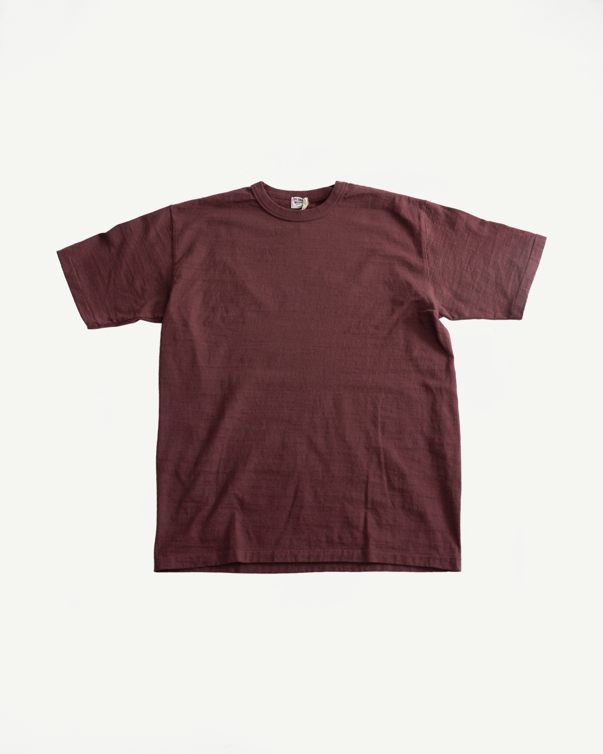 7.7oz Fallen Cotton Midweight T-Shirt S/S - Bordeaux, featuring a plain, short-sleeved design with a subtle natural slub texture, laid flat on a white background.