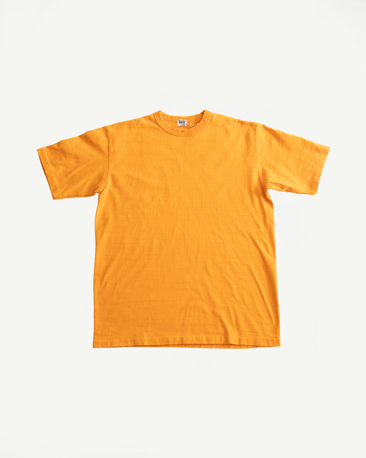 7.7oz - Fallen Cotton Midweight T-Shirt S/S - Fade Orange, showcasing a vibrant orange hue, laid flat. Highlights its textured slub jersey fabric and classic crew-neck design, emphasizing durability and comfort.
