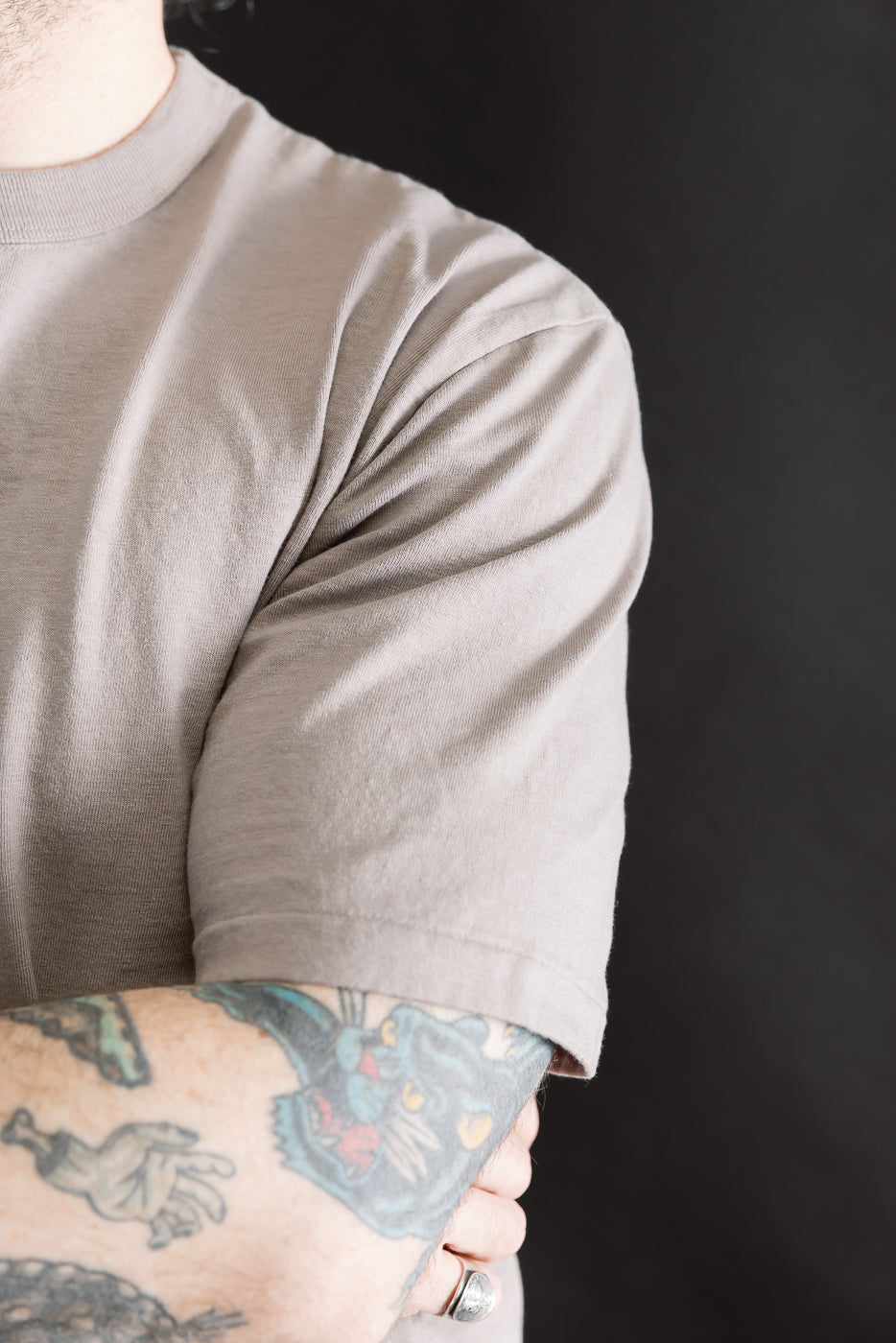 Person wearing the Fallen Cotton Midweight T-Shirt S/S - Grey, showcasing its short-sleeve design, textured recycled cotton slub jersey fabric, and classic construction with a clean, familiar silhouette.