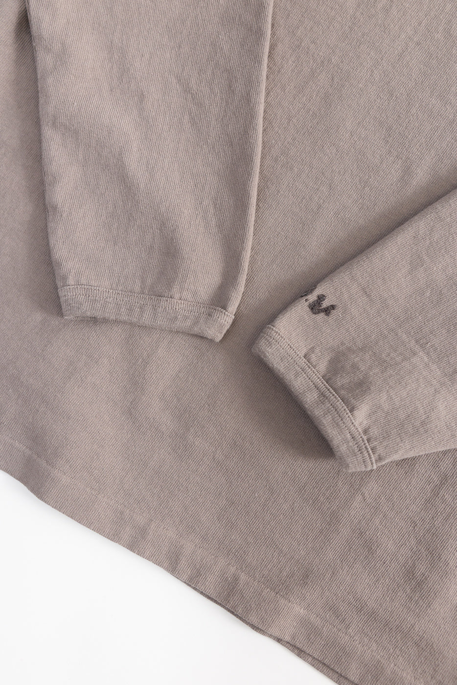 Close-up of grey heavyweight long sleeve tee fabric texture and sleeve cuffs, front side