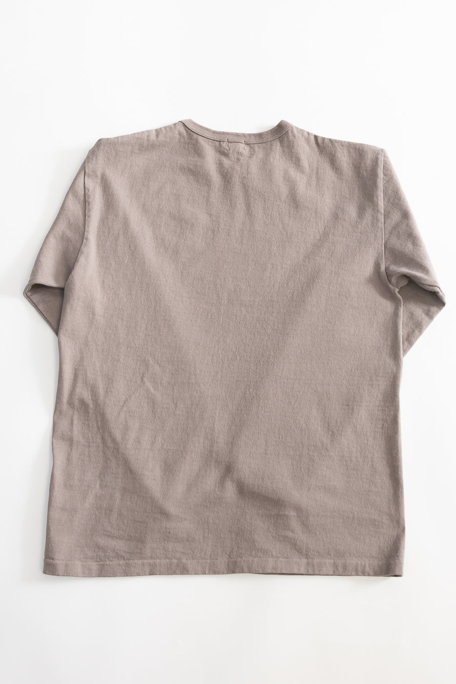 Flat lay of grey heavyweight long sleeve tee, back side, showing plain hem and textured fabric.