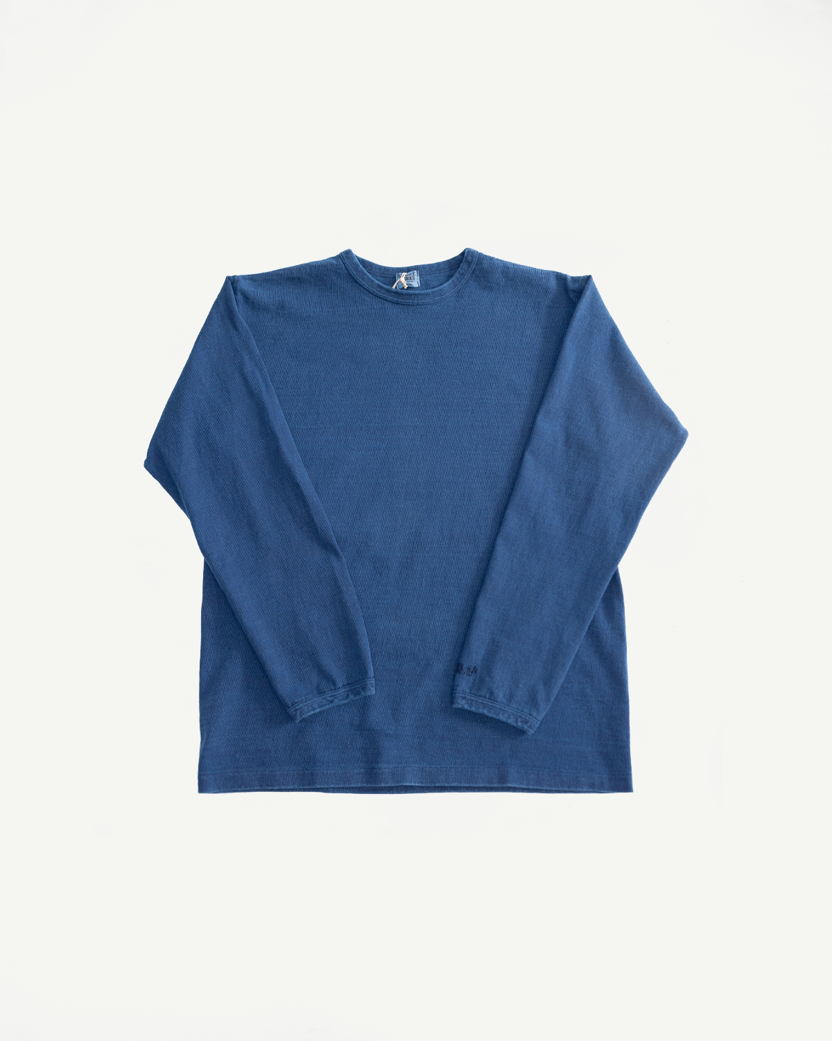 Flat lay front view of indigo-dyed heavyweight long sleeve tee, showing crew neck and sleeve cuffs.