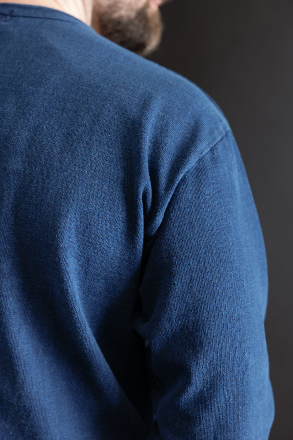 Close-up of indigo-dyed heavyweight long sleeve tee, male model, back shoulder detail