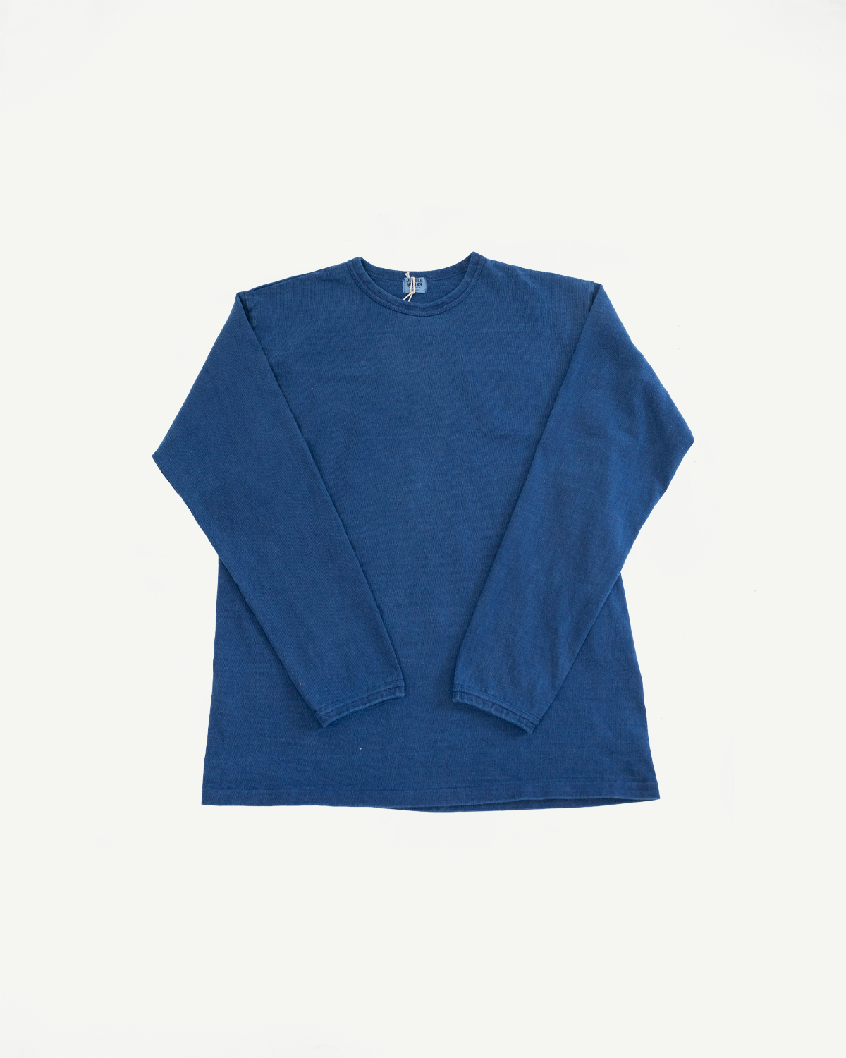 Front flat lay of blue long-sleeve shirt with ribbed texture and tag detail