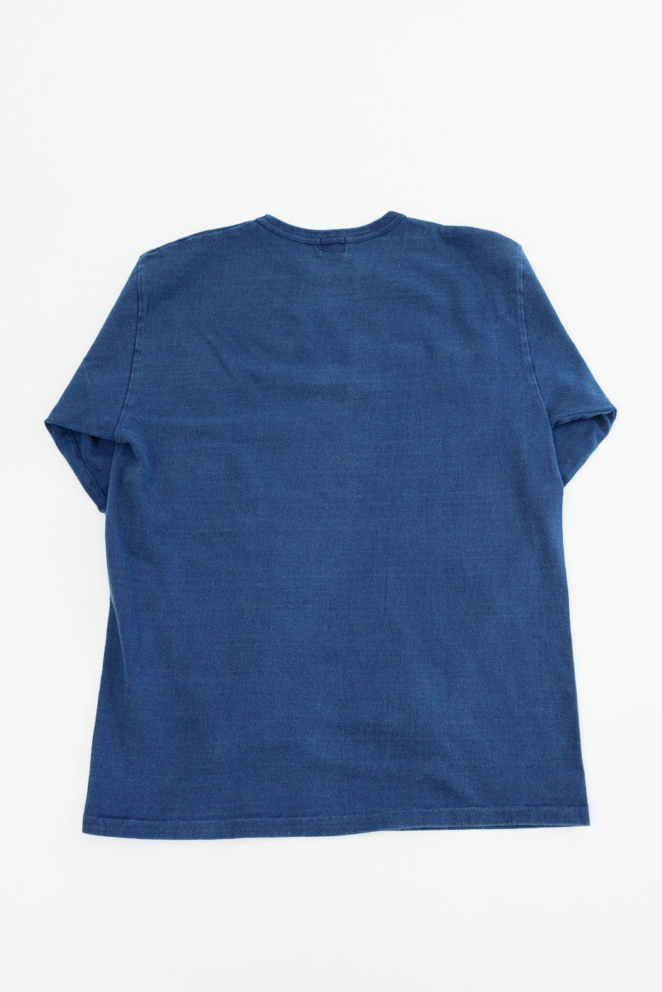 Back view of navy blue short-sleeve t-shirt, flat lay, showing crew neck and hem detail