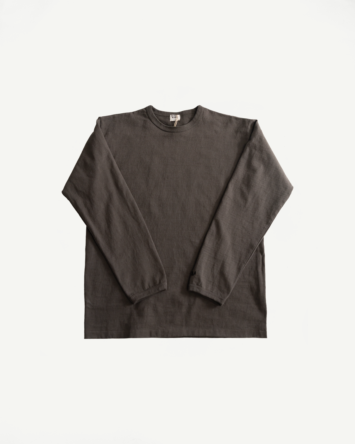 Front flat lay of heavyweight long sleeve tee in charcoal, shows crew neck and full sleeves.