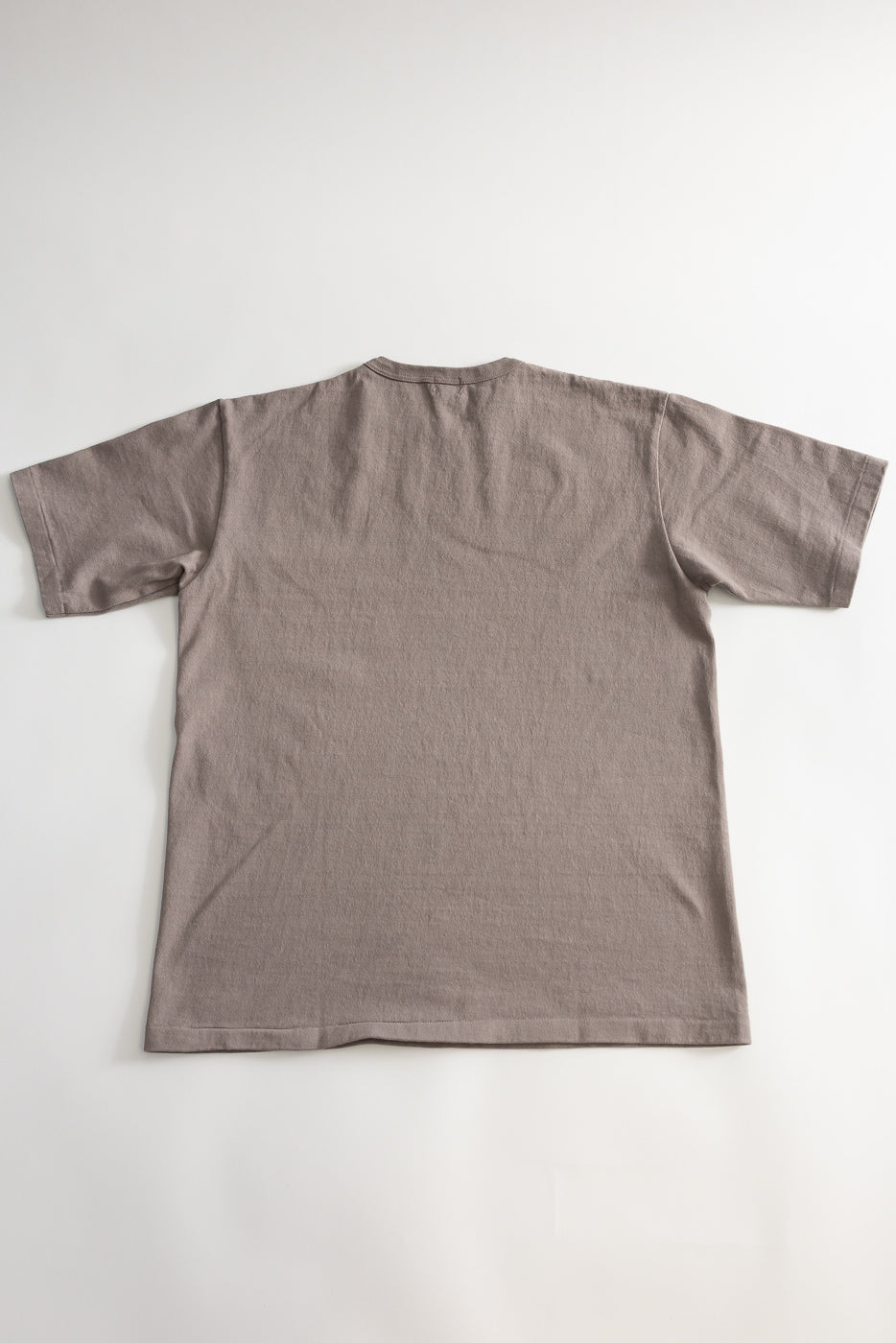Flat lay of grey heavyweight short sleeve tee, back view, showing crew neck and hem details.