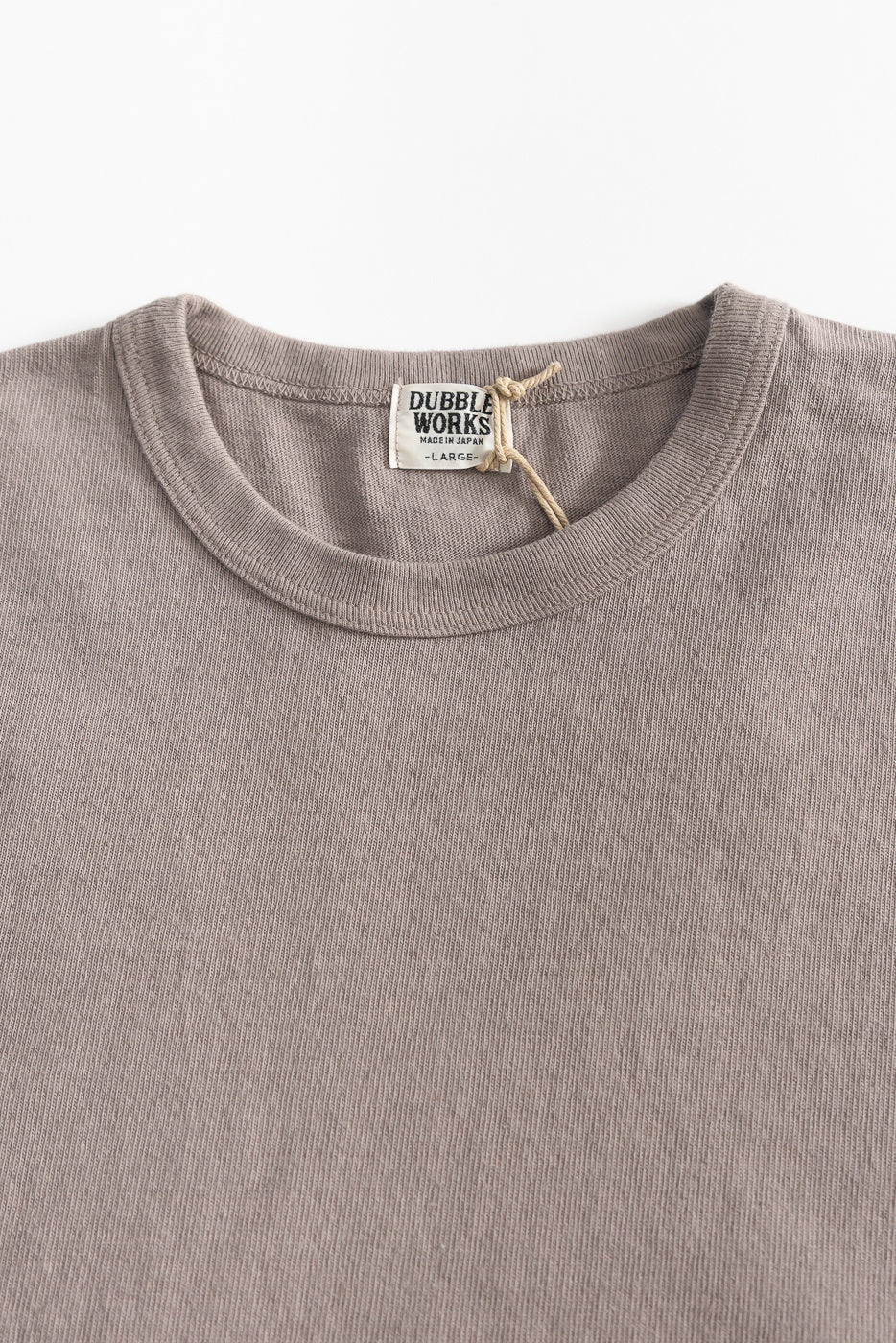 Close-up front view of heavyweight grey tee, showing ribbed crewneck collar and fabric texture.