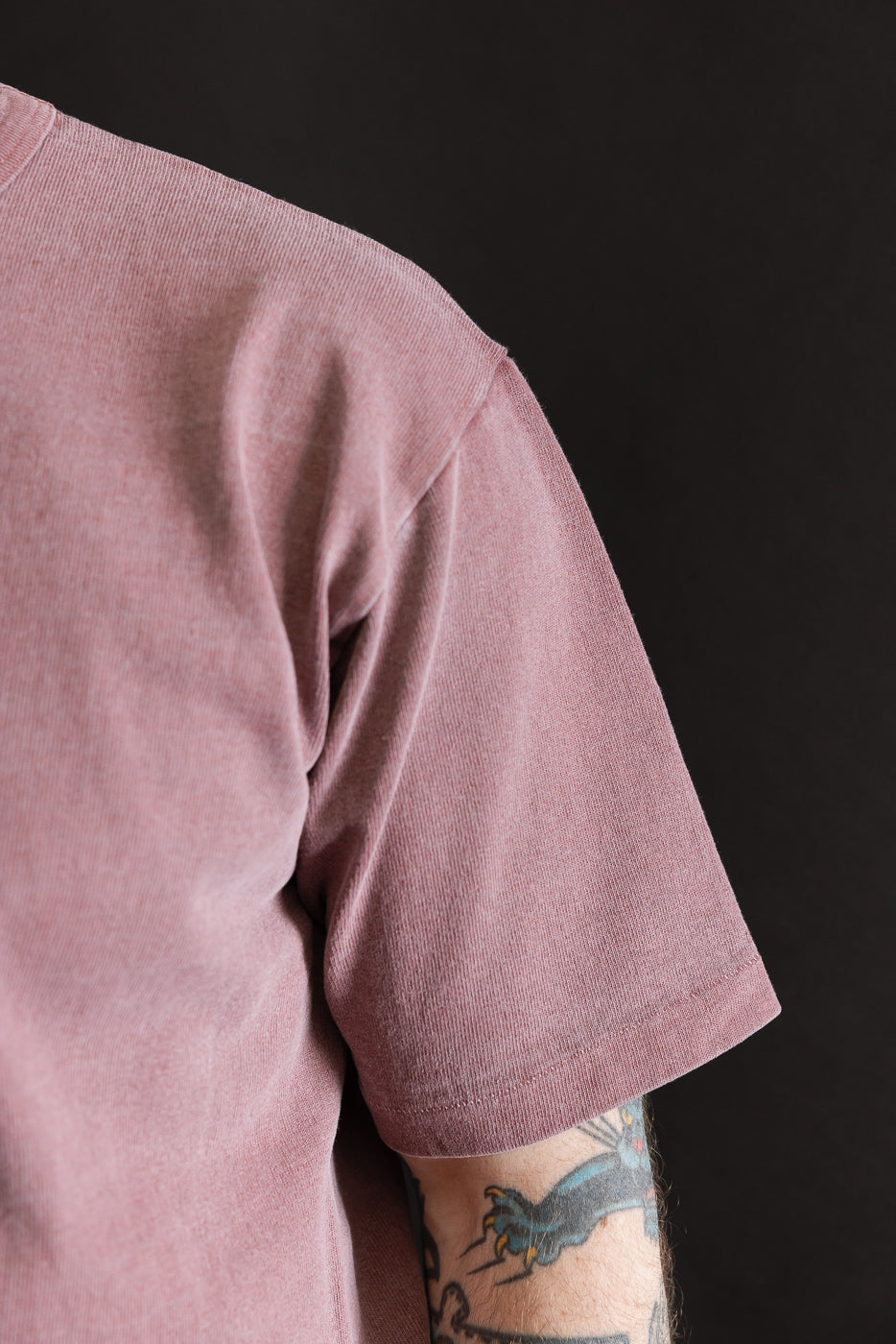 Close-up of right sleeve and shoulder of men's bordeaux heavyweight tee on male model, 5'9