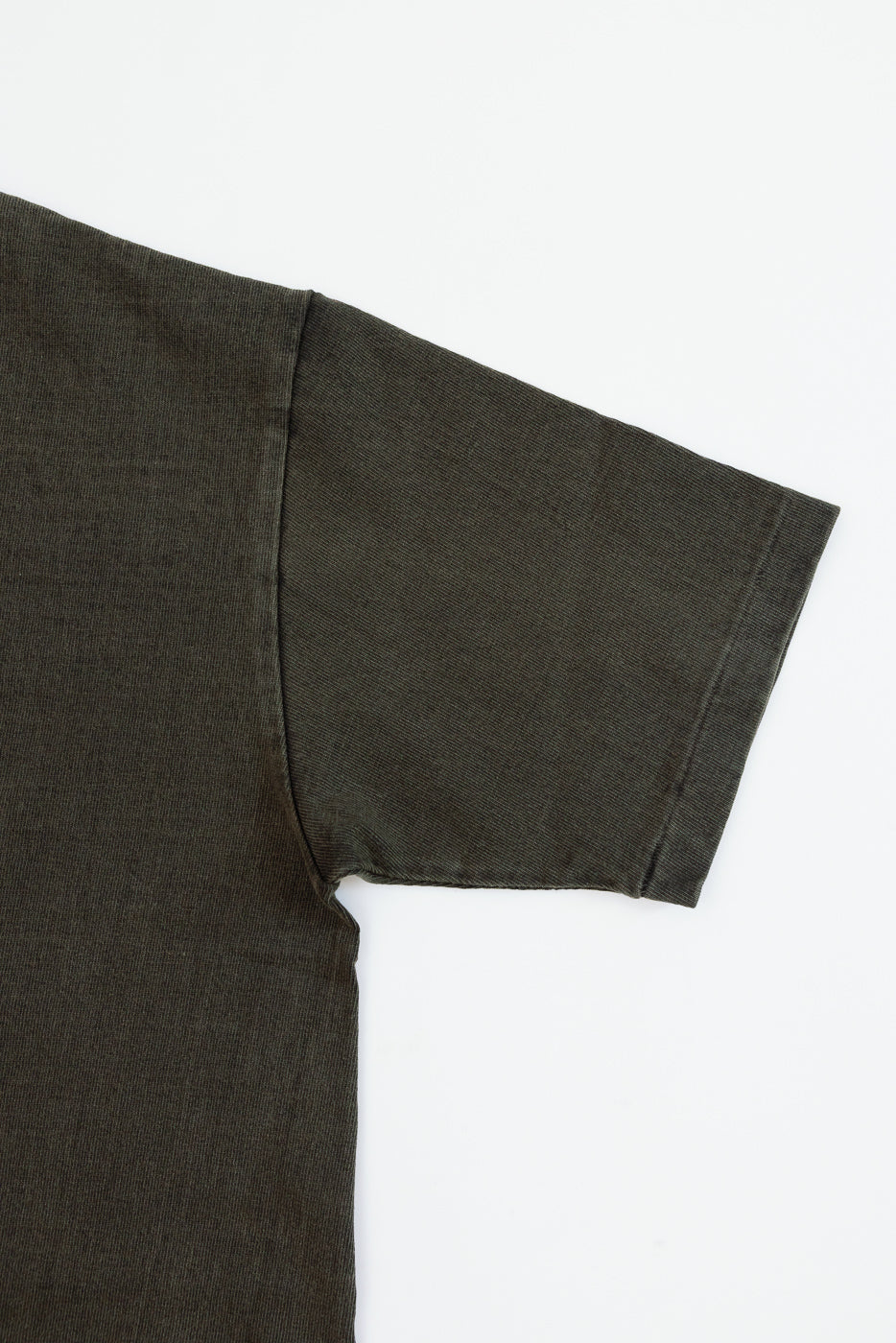 Close-up front view of olive green t-shirt sleeve, showing ribbed texture and clean hem detail
