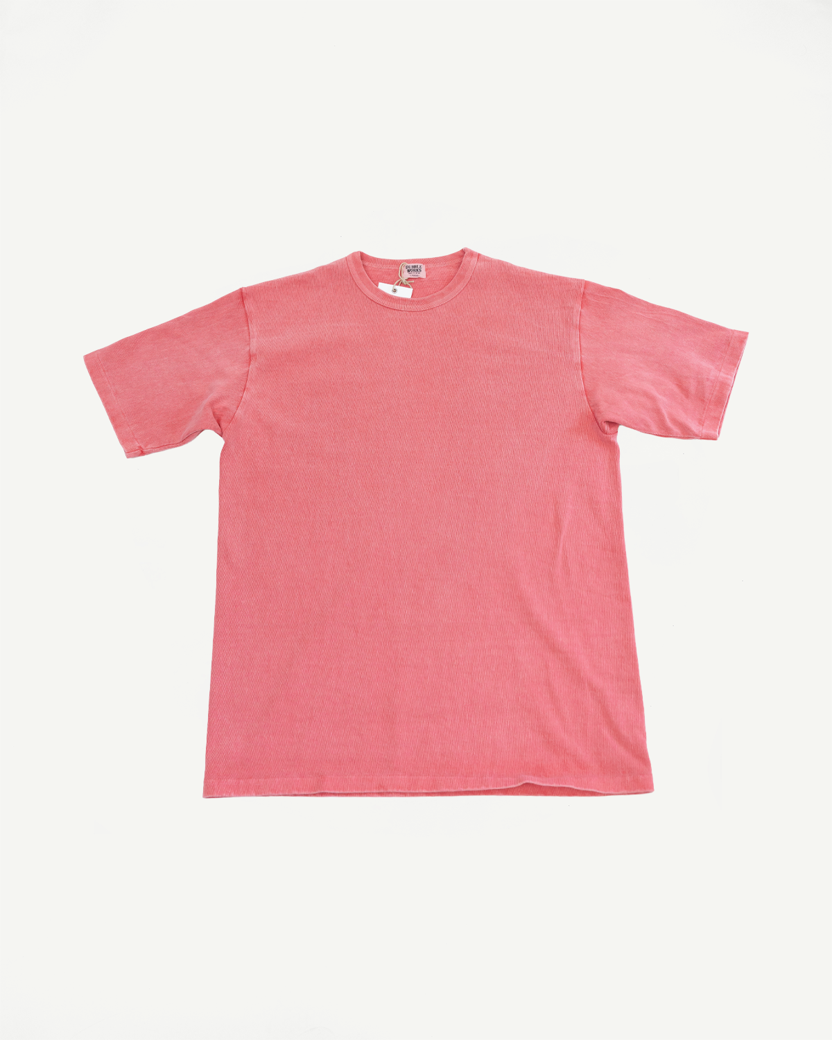 Front view of coral pink short-sleeve t-shirt with ribbed texture and tag detail