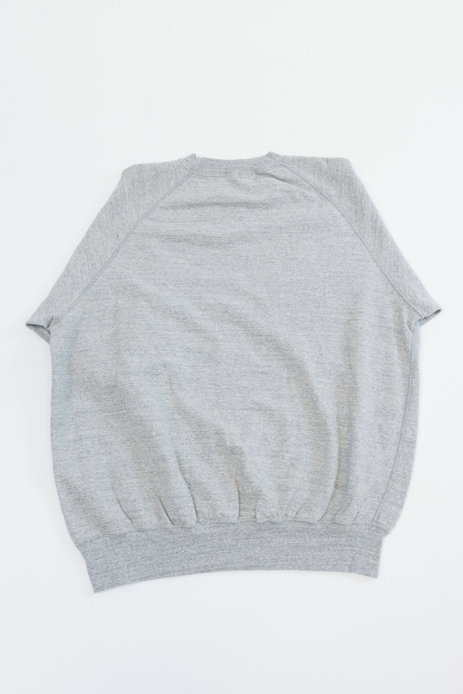 Gray raglan sleeve sweatshirt back view, flat lay, ribbed hem detail