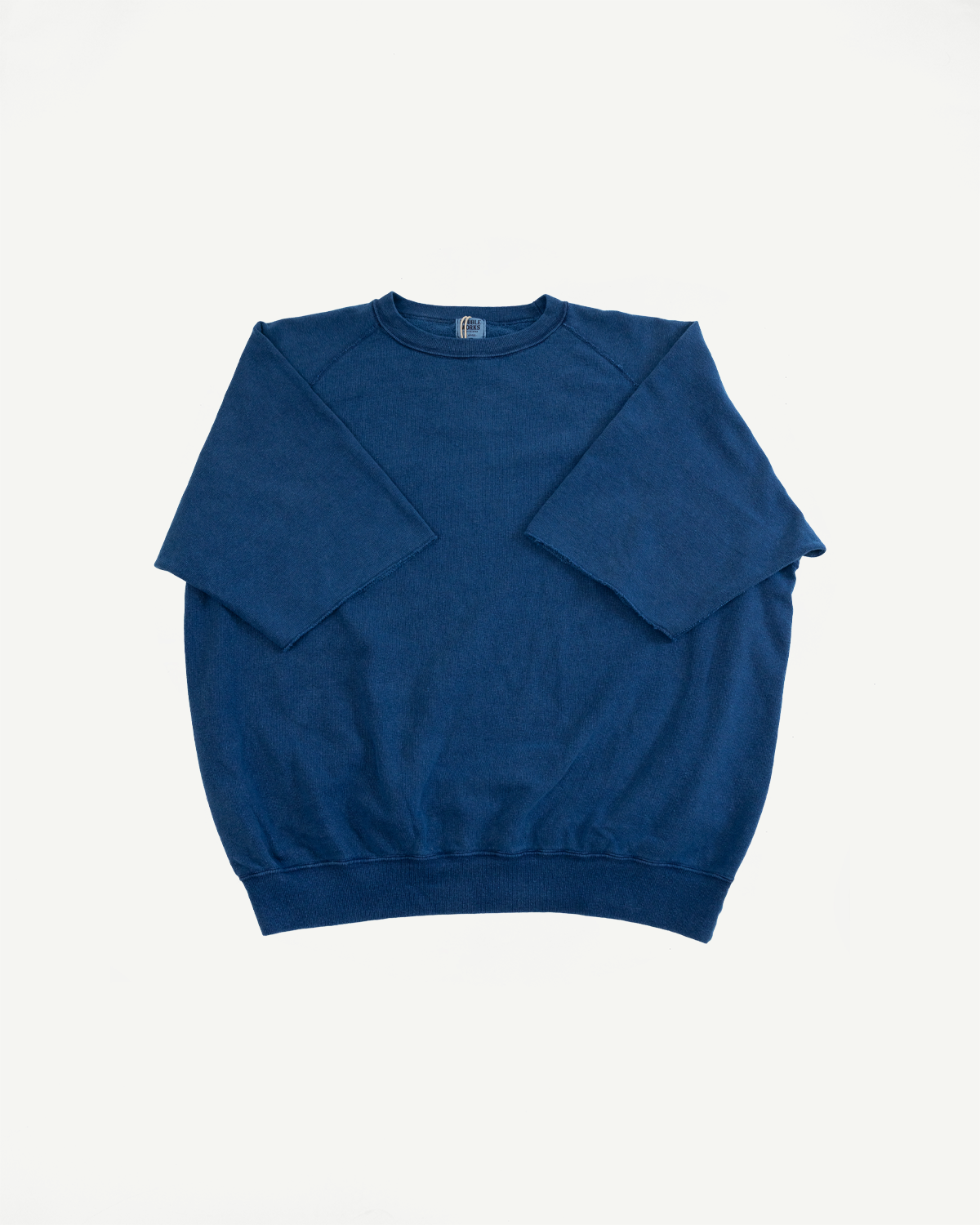Front flat lay of navy blue crewneck sweatshirt with ribbed hem and tag detail