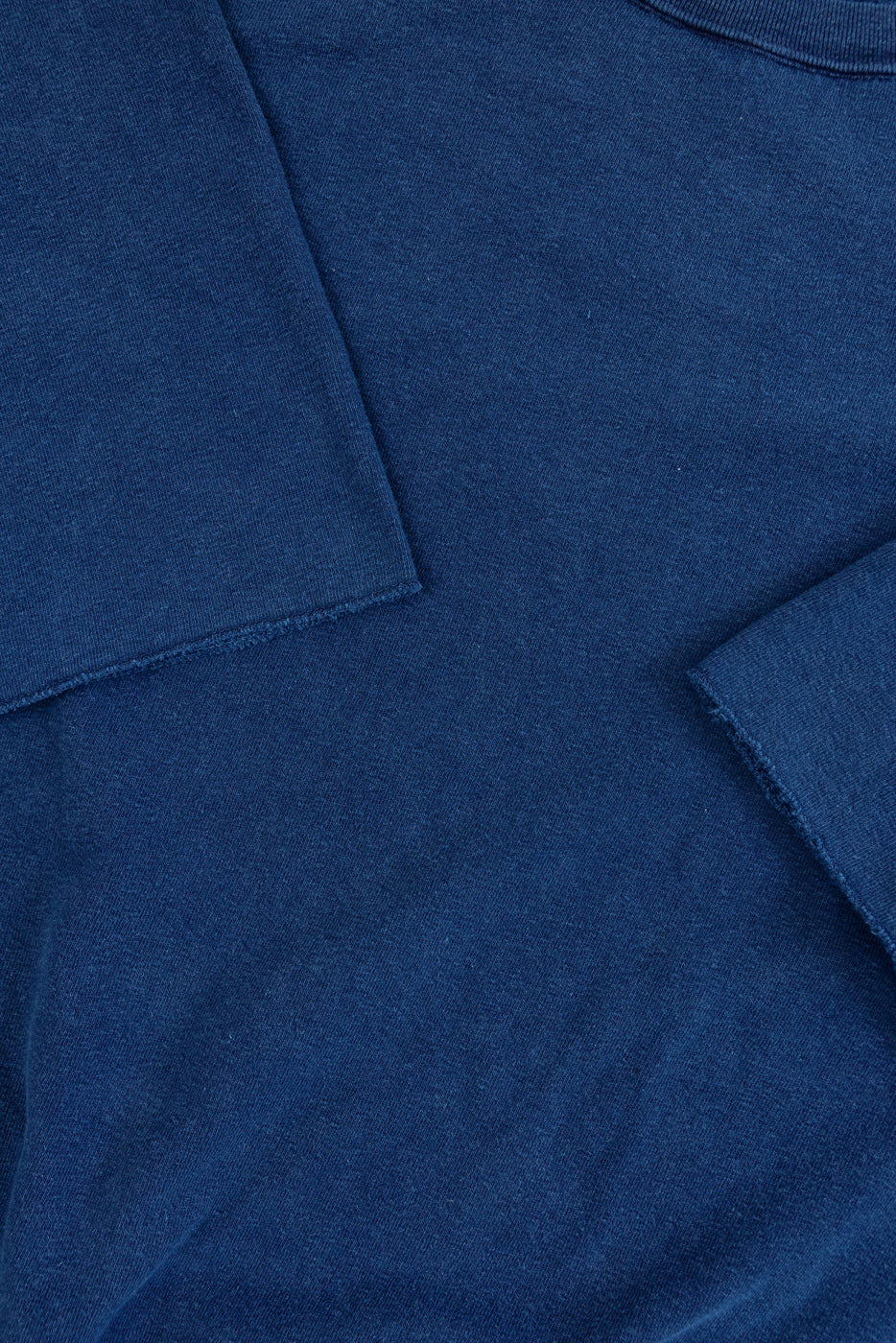 Close-up of navy blue sweatshirt front, showcasing fabric texture and pocket detail