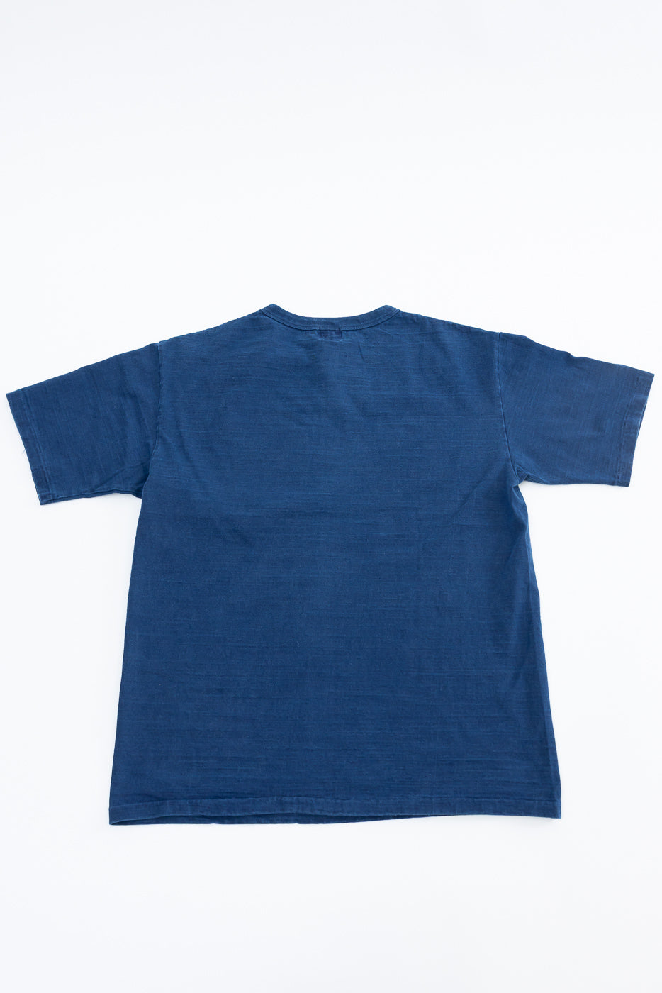 Back view flat lay of Dubble Works indigo cotton midweight tee, short sleeve, casual unisex shirt