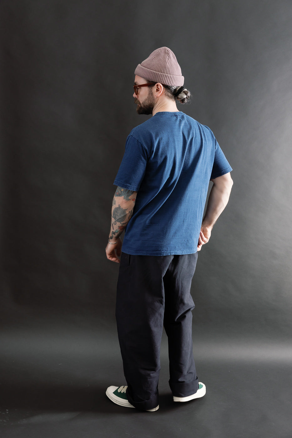 Male model 5'9 165lbs athletic build wearing indigo Dubble Works tee, back full body view