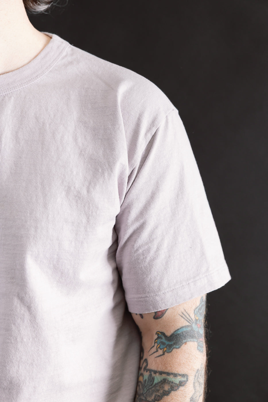 Close-up front view of Dubble Works lavender midweight cotton tee, male model 5'9