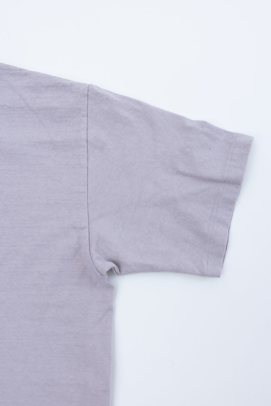 Close-up of Dubble Works Fallen Cotton lavender t-shirt, flat lay, right sleeve detail, front view