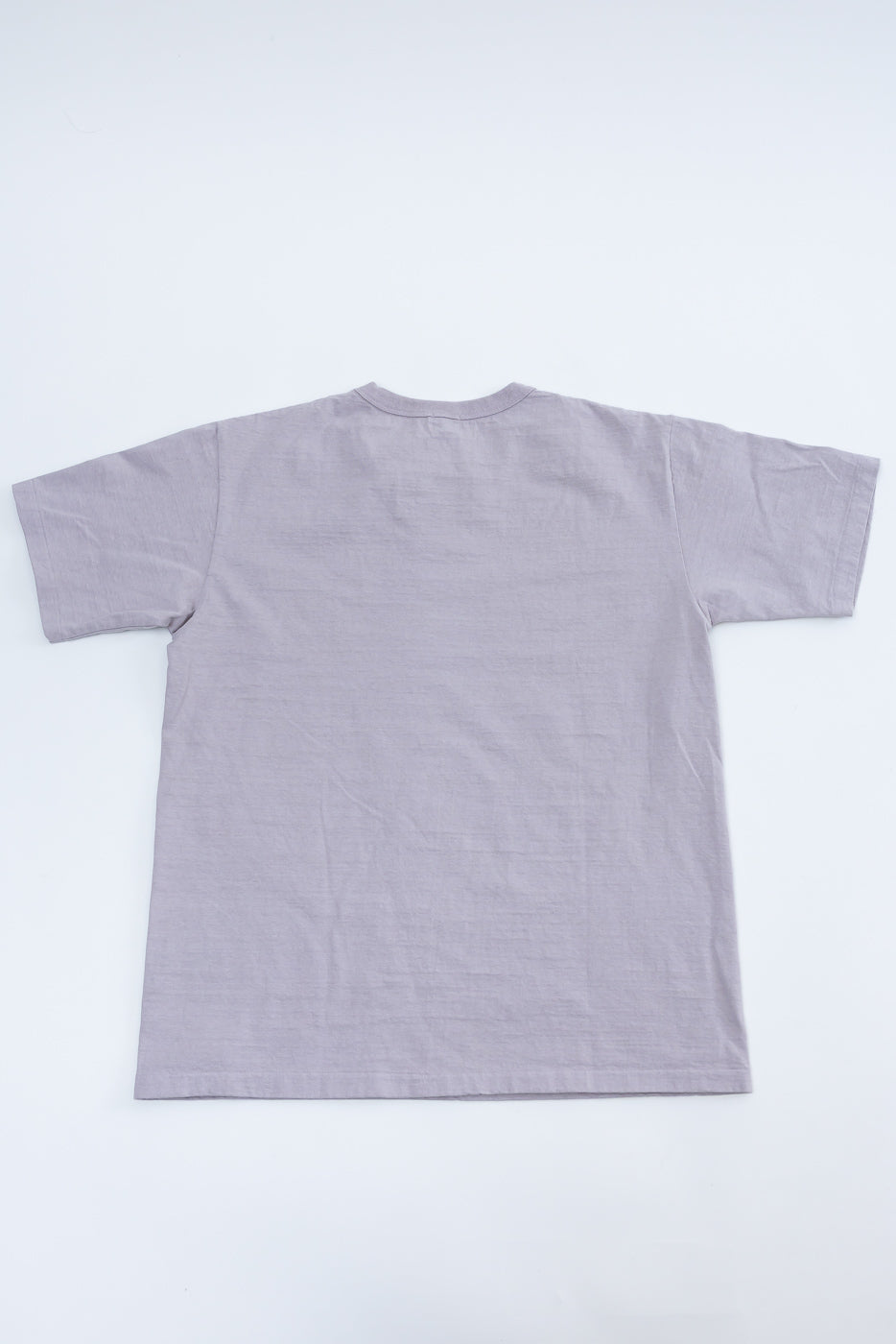 Flat lay of Dubble Works lavender short sleeve tee, back view, showing straight hem and crewneck.