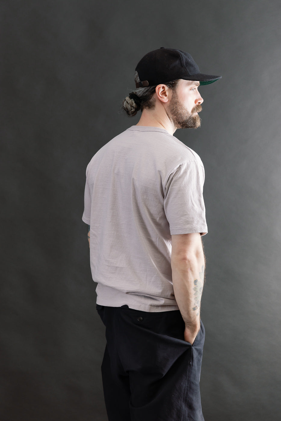 Male model 5'9 165lbs athletic build wearing Dubble Works lavender tee, back side view