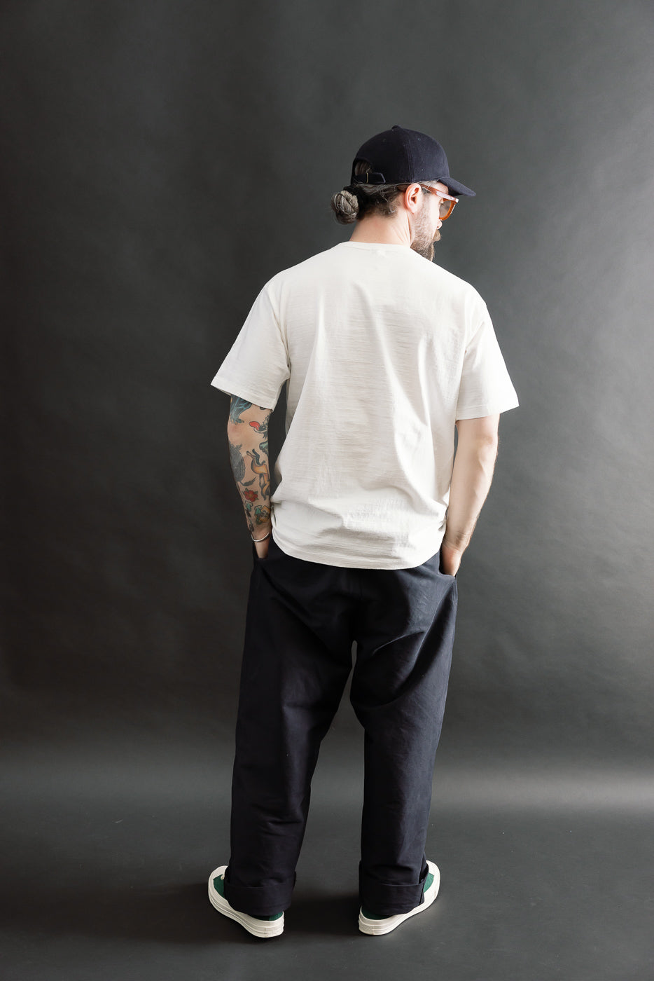 Male model 5'9, 165lbs, athletic build, wearing Dant midweight off-white tee, full body back view